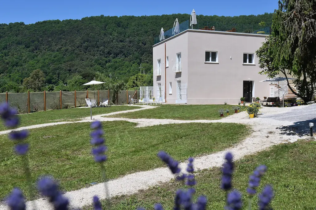 Edificio B&B con giardino e colline verdi sullo sfondo